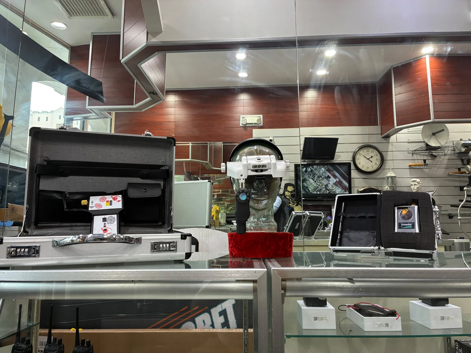 Counter-surveillance equipment and open cases on the SPY WORLD store counter