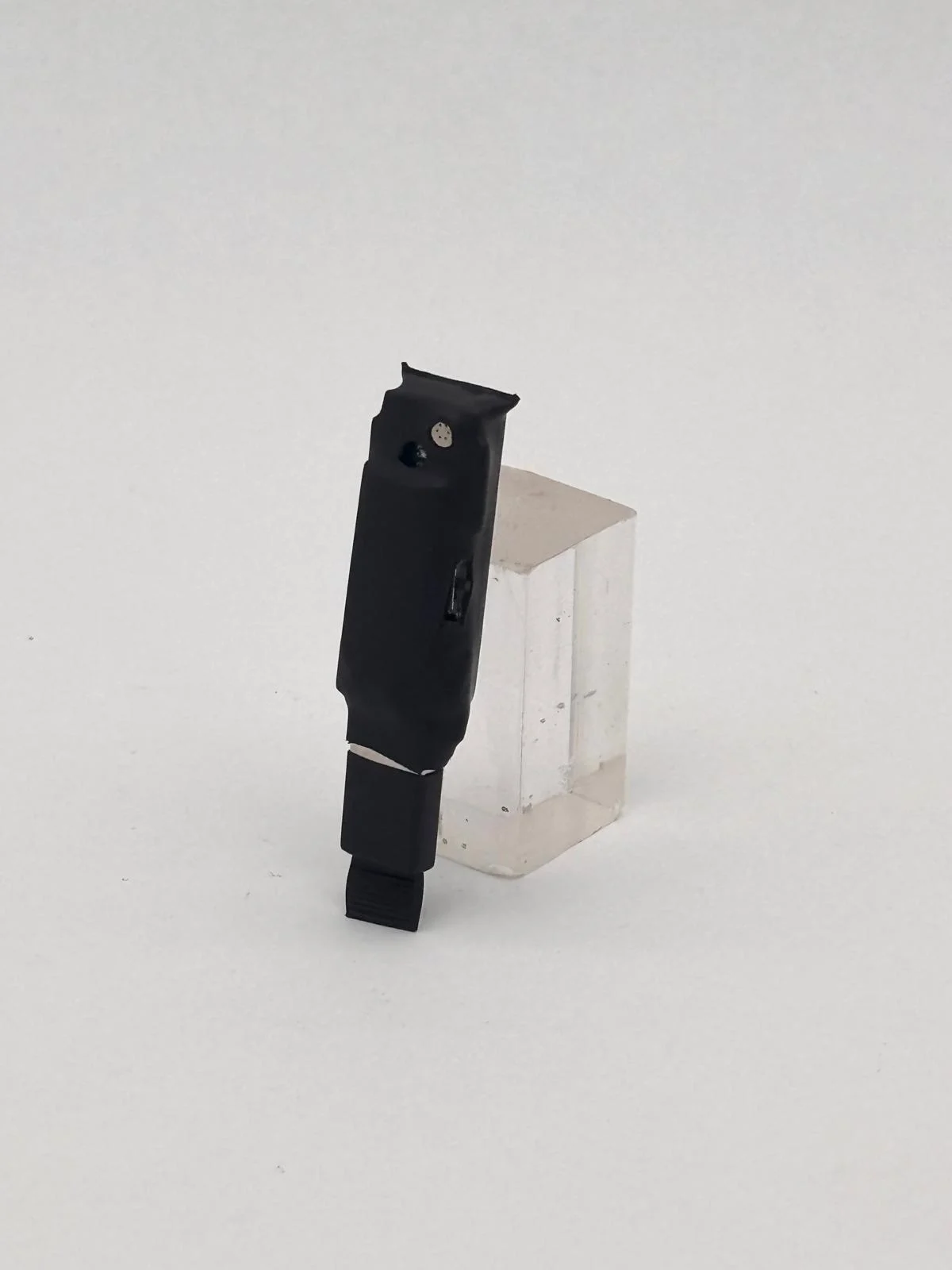 Another view of the device, showing its shape and connection area.