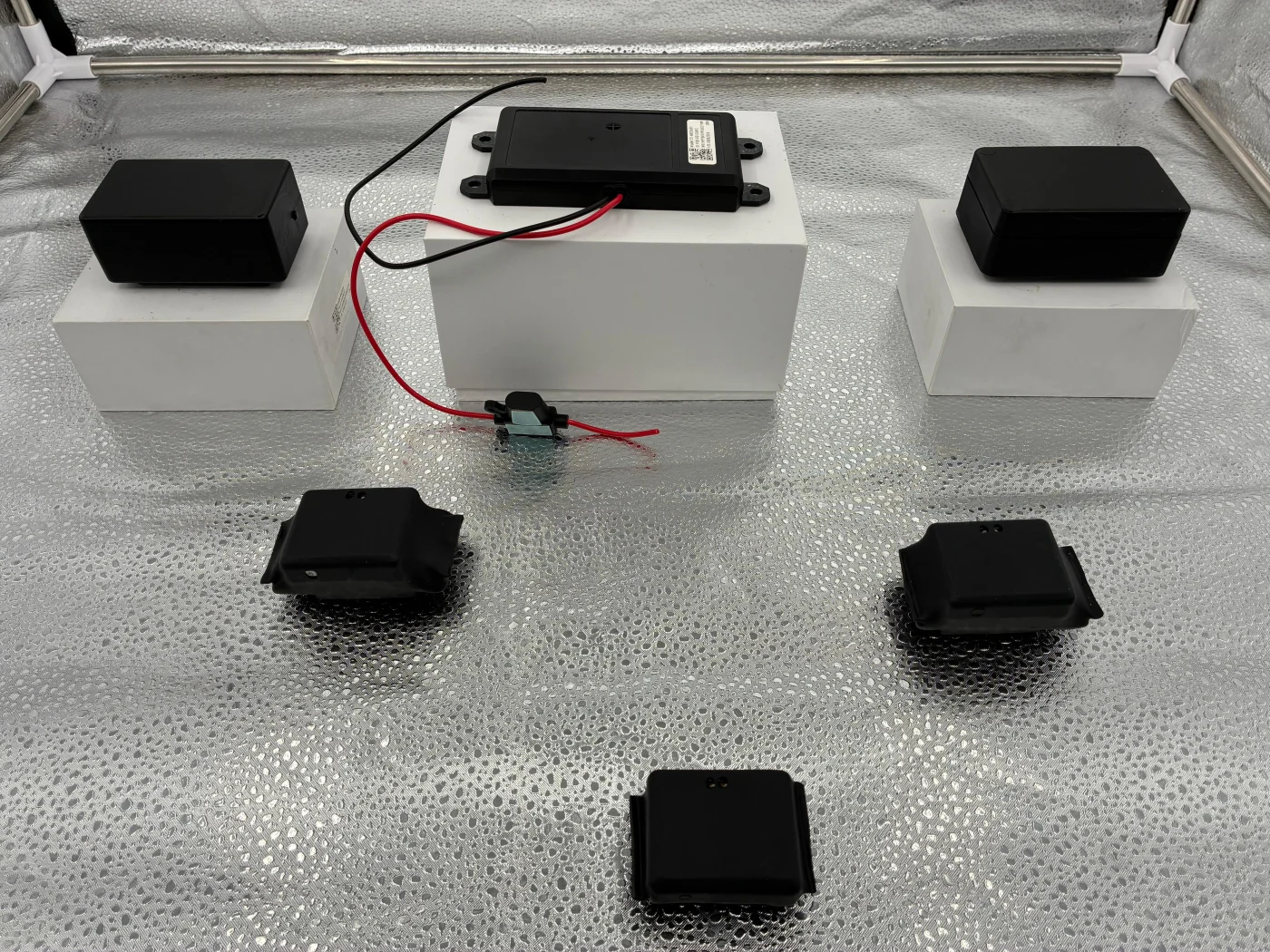 Several equipment formats displayed together, including a wired unit in the center at the back.