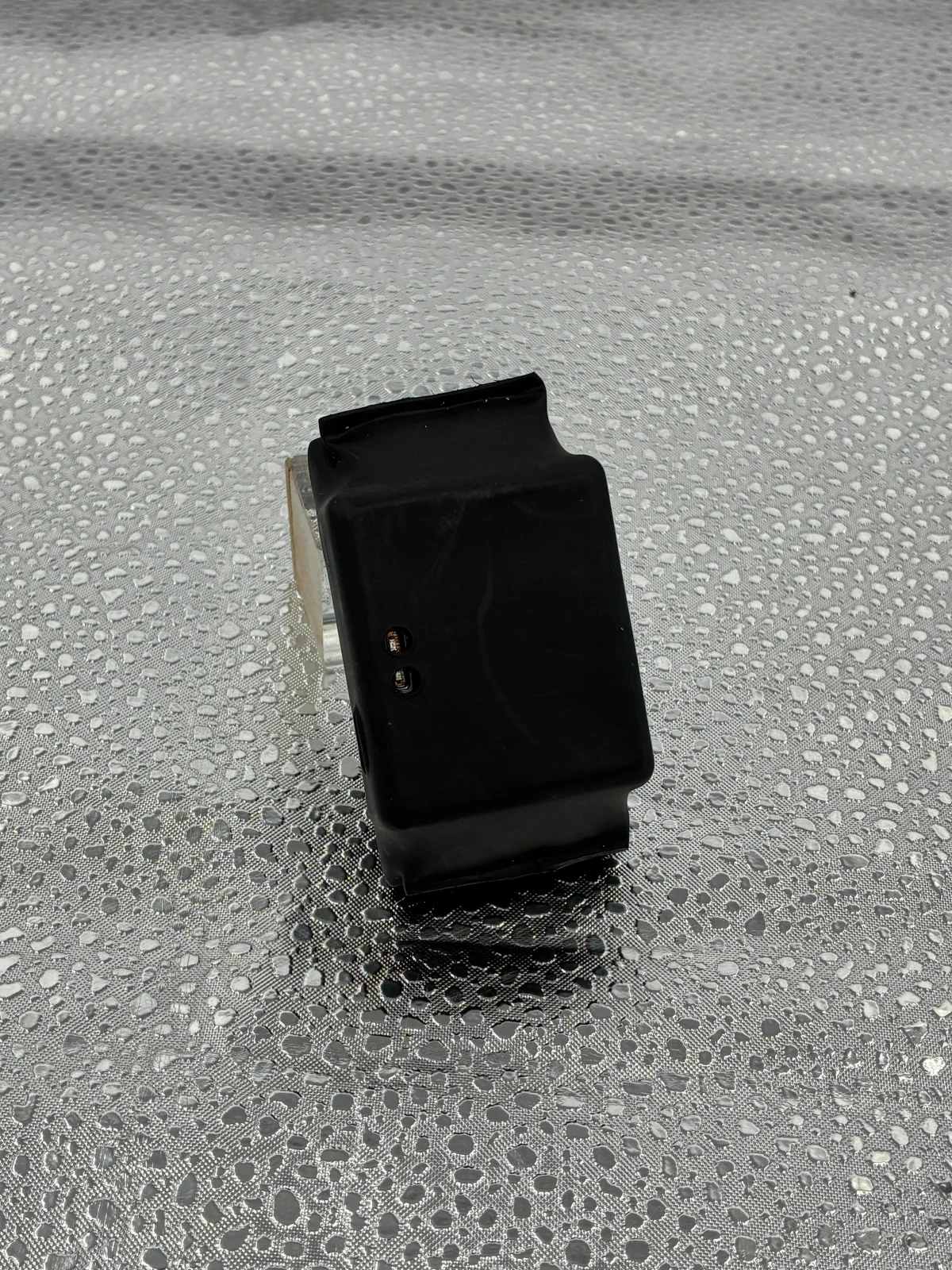 A smaller black unit shown separately for a closer view of its housing.