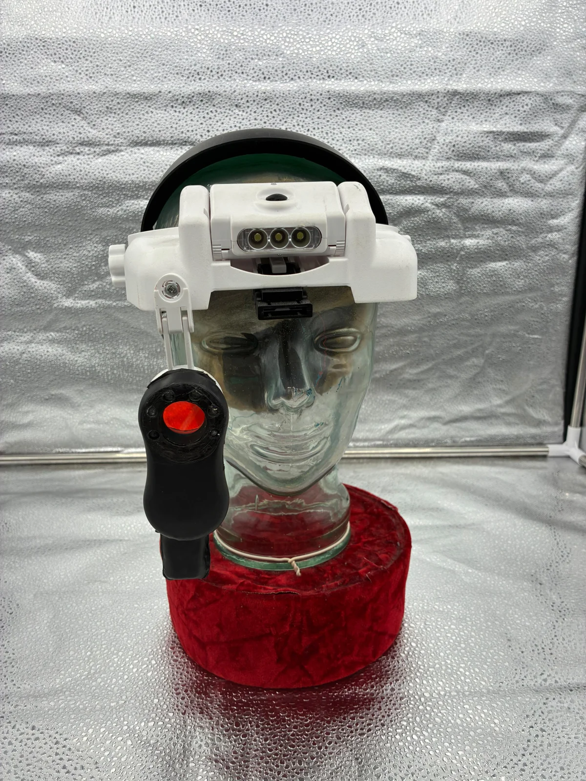 Close-up of detection equipment displayed on a glass mannequin head