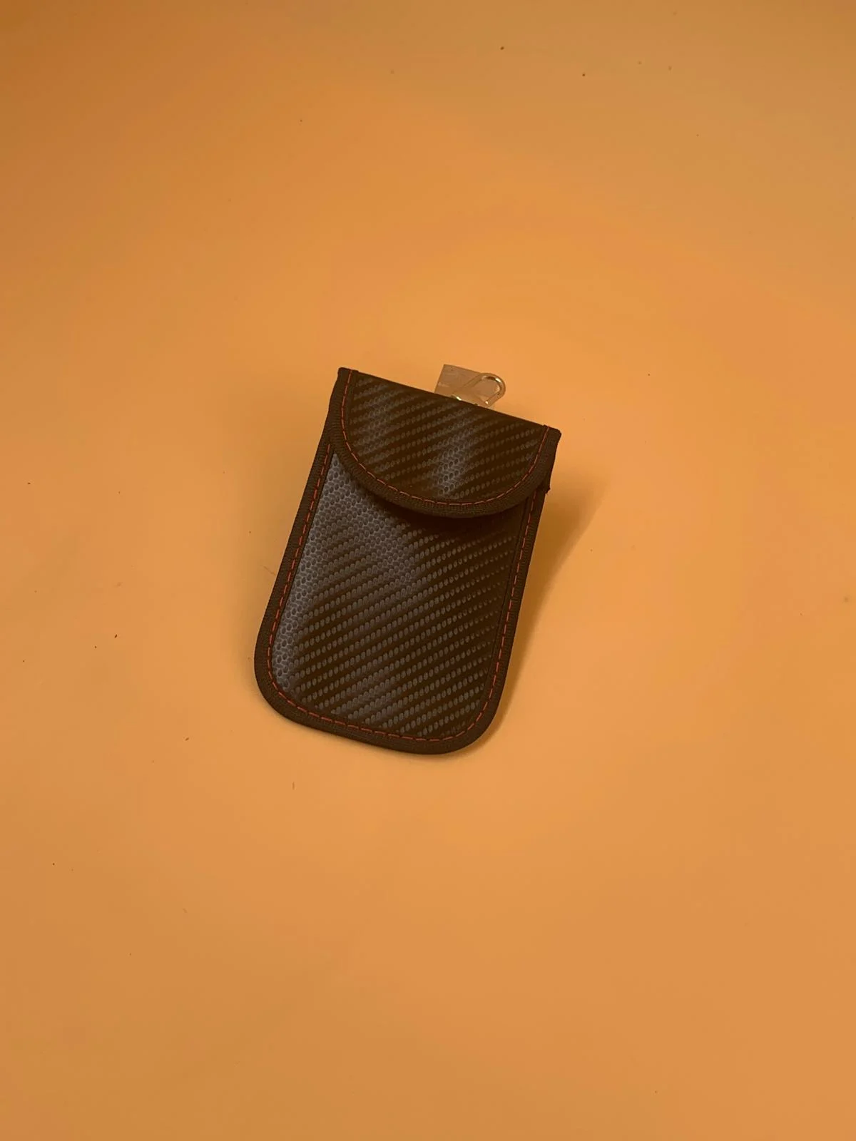 A compact Faraday pouch format for a compatible smart car key or small electronic item.