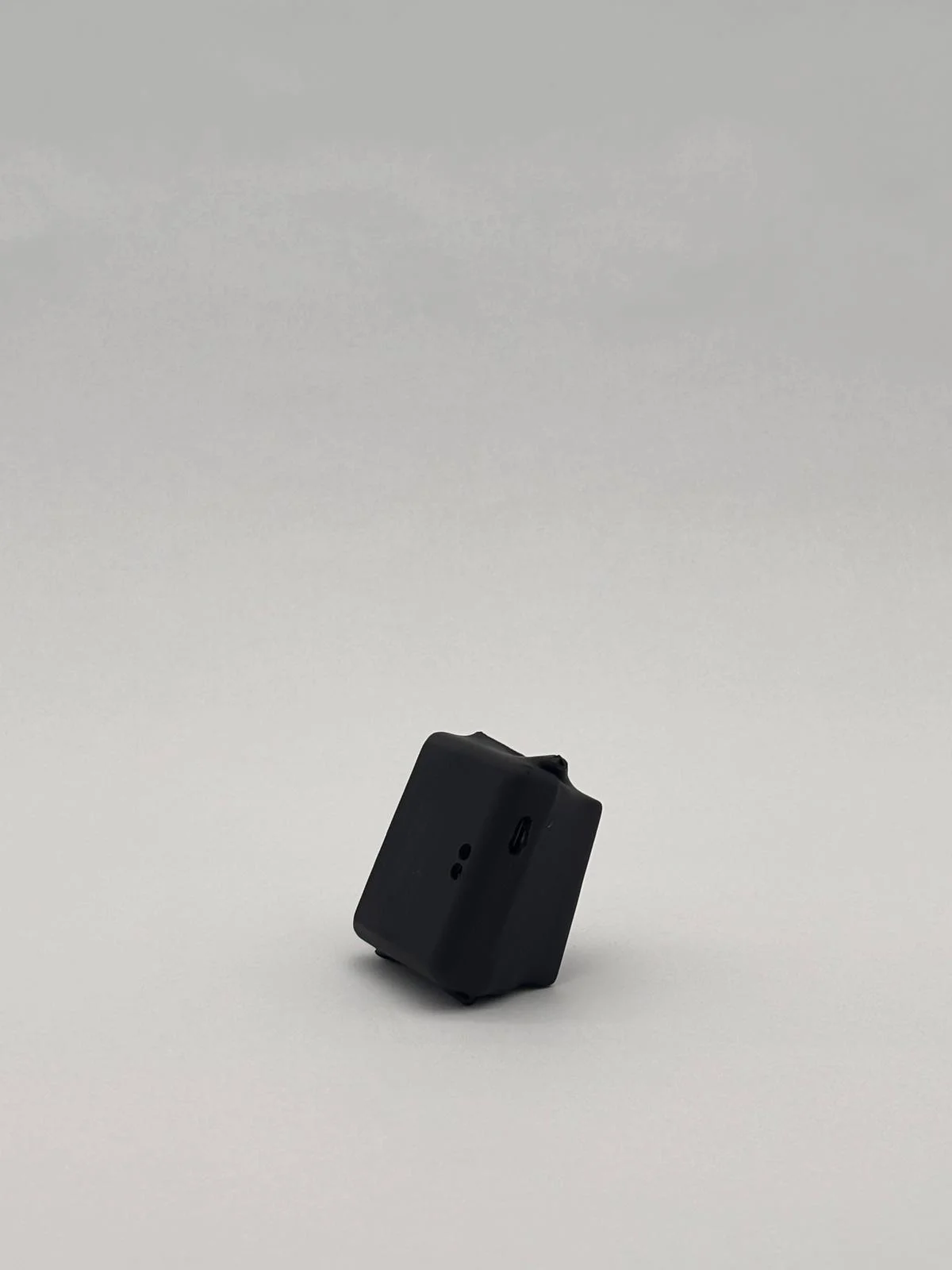 Compact black unit shown from an angle, with a side port visible.