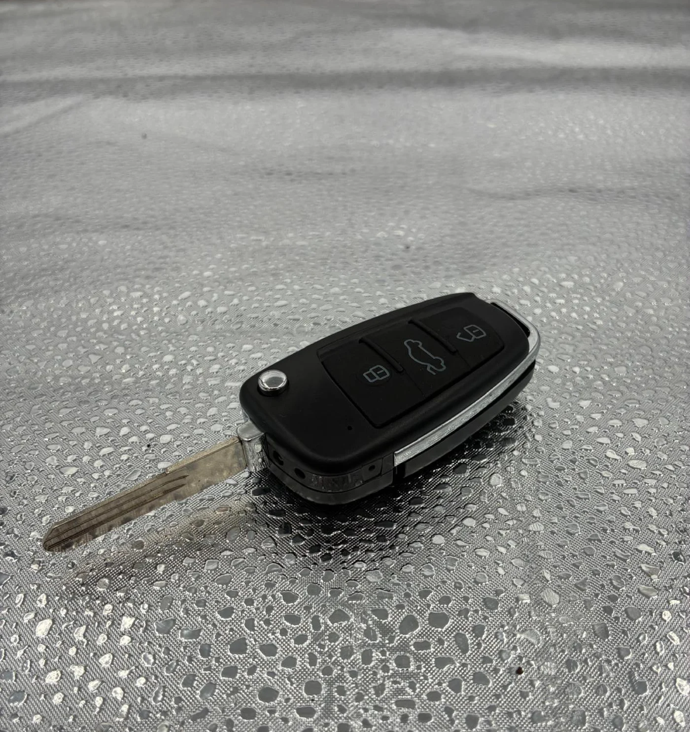 Side view of a key-style camera with its key blade extended