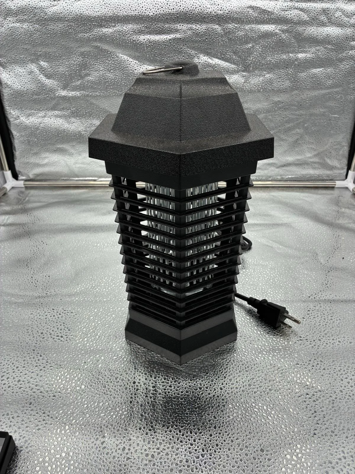 Outdoor camera in a dark insect-zapper-style housing