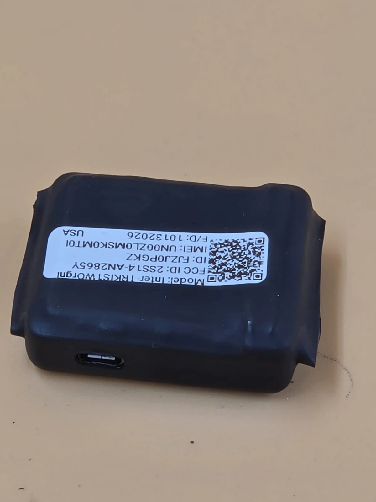 Close-up of the device's labeled side, with a port visible near the edge.