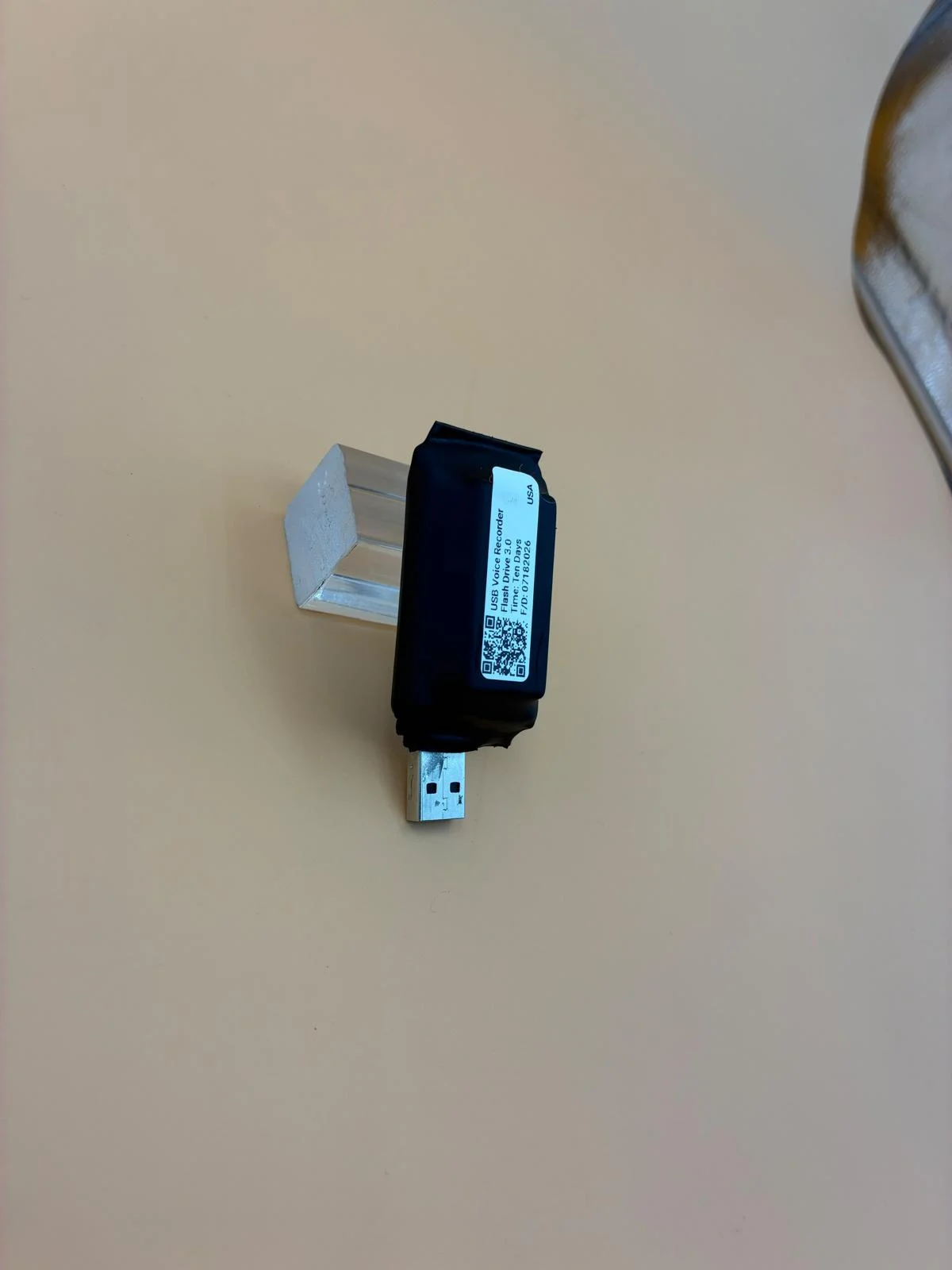 A compact black recorder with its label and USB connector visible.