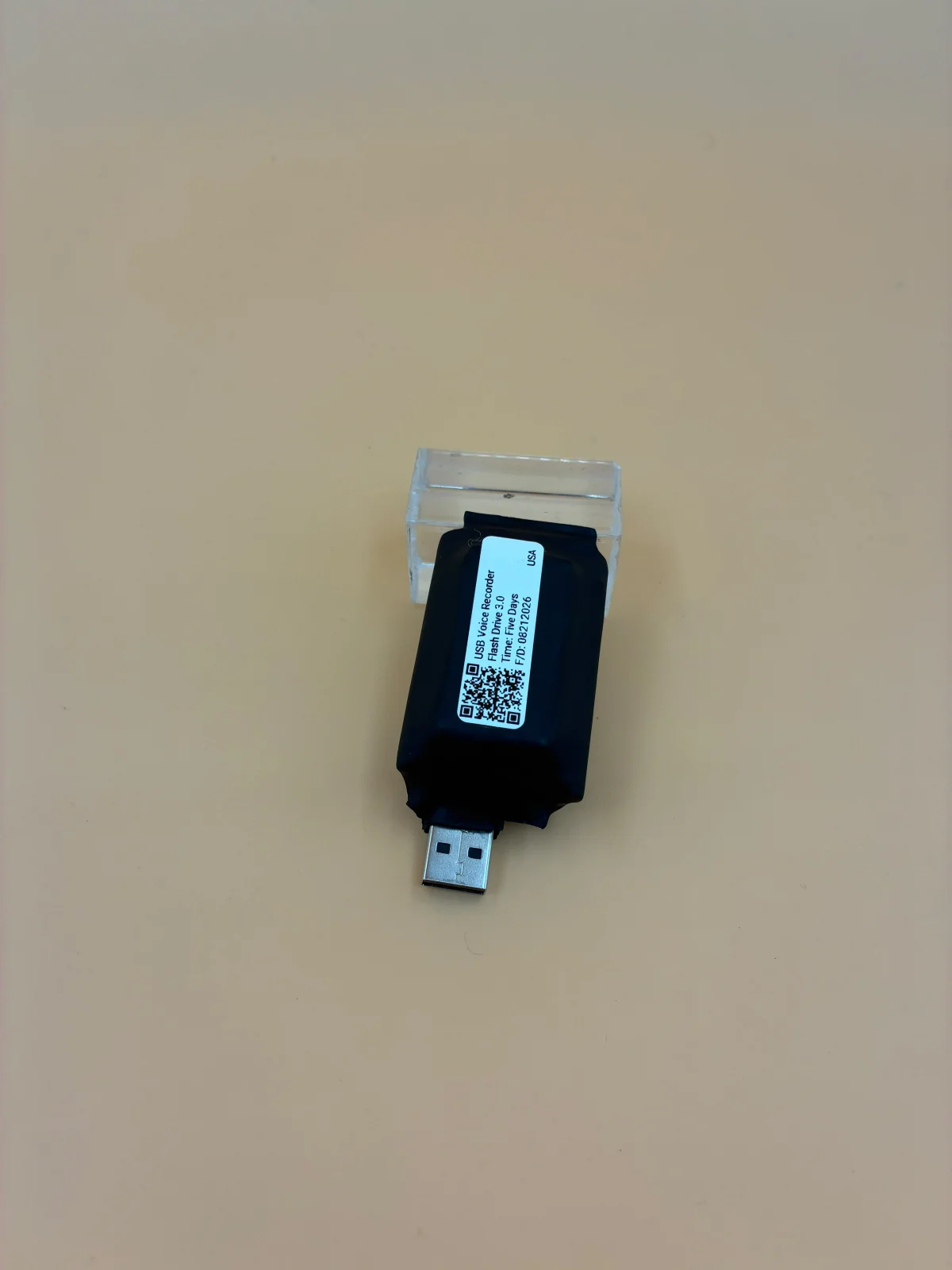 A closer view of a black recorder with its USB connector visible.